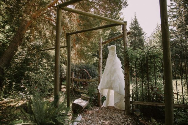 anacortes wedding venue wisteria gardens wedding dress on trellis in the sunlight