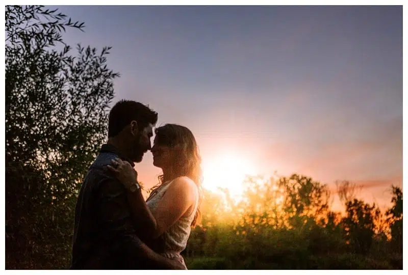 Premier Snohomish & Seattle Wedding Photographer | GSquared Weddings Photography A couple stands close together, facing each other with foreheads touching, silhouetted against a colorful Snohomish sunset sky—perfect for a romantic Seattle wedding engagement. Trees frame the magical moment in the background. 47.9129° N, 122.0982° W | Serving Snohomish, Seattle , Orlando & Beyond
