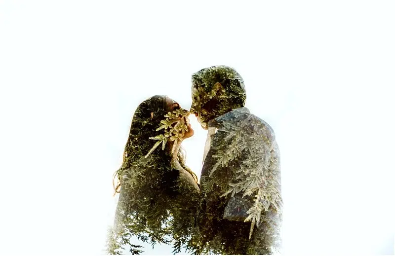 Premier Snohomish & Seattle Wedding Photographer | GSquared Weddings Photography A double exposure image of a couple facing each other, their silhouettes overlaid with tree branches and leaves, set against a bright white background—a dreamy Snohomish Seattle wedding engagement portrait. 47.9129° N, 122.0982° W | Serving Snohomish, Seattle , Orlando & Beyond