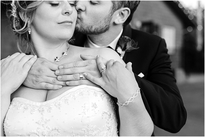 Premier Snohomish & Seattle Wedding Photographer | GSquared Weddings Photography A groom gently kisses the bride on her cheek, holding her hands over her chest. The bride wears a strapless wedding gown and jewelry. This black and white image captures a romantic atmosphere at their Snohomish Seattle wedding. 47.9129° N, 122.0982° W | Serving Snohomish, Seattle , Orlando & Beyond