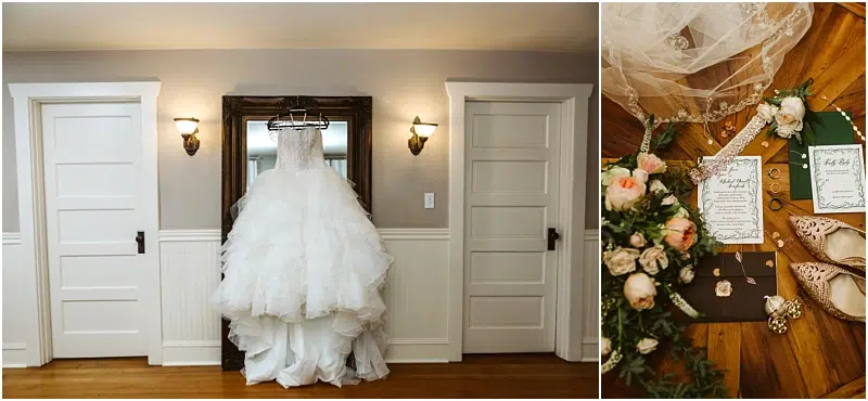 A white wedding dress hangs on a mirror between two white doors; next to it, wedding accessories, invitations, flowers, and shoes are artfully arranged on a wooden surface in a charming Snohomish setting. Snohomish Wedding Photography