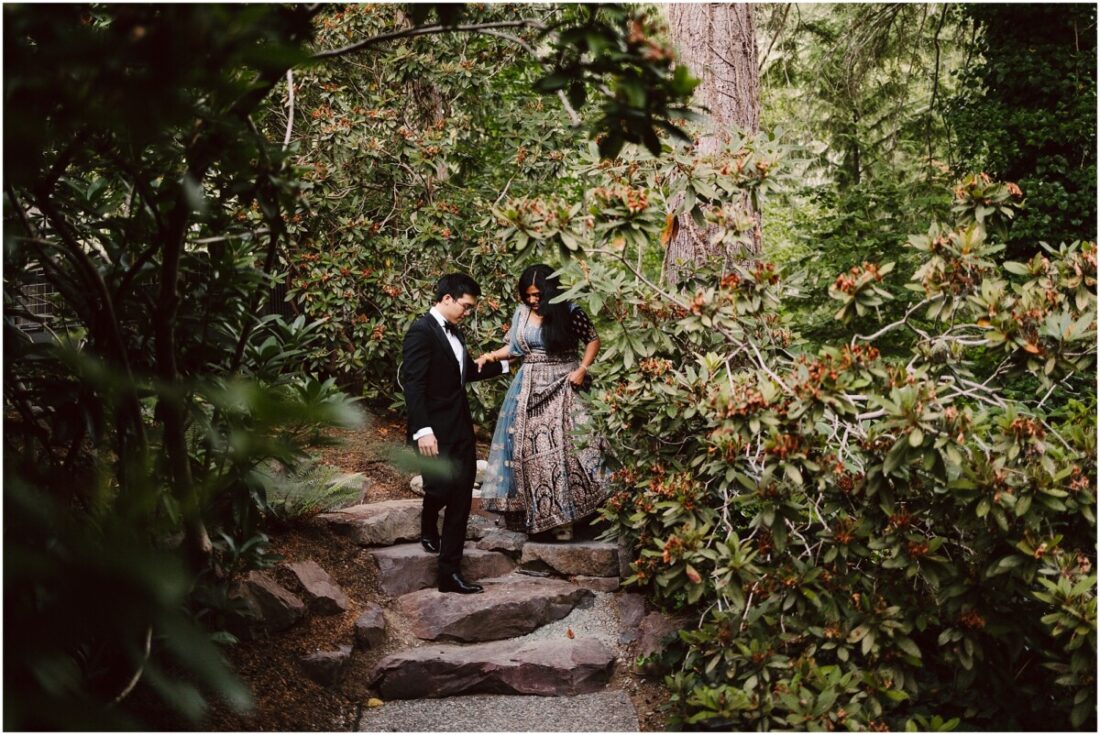Gray Bridge Wedding Portraits bride in a lehenga and groom in a suit in the woods