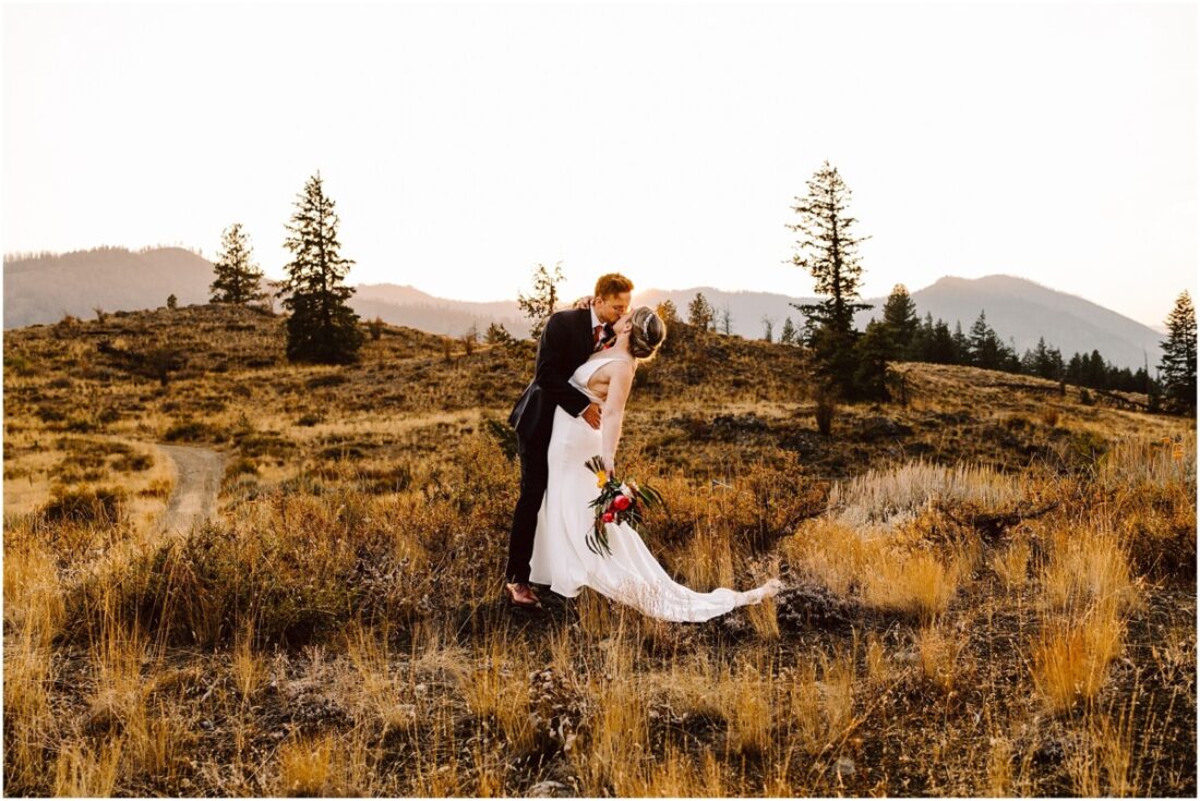 Sun Mountain Lodge Fall Wedding Bride and Groom in the sunset with the dried grass and mountains and trees