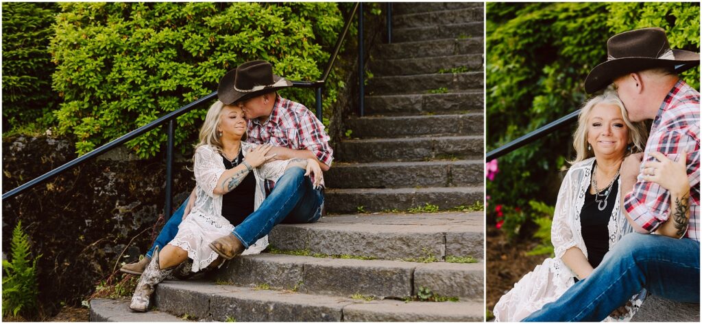 Snohomish Wedding Photographer GSquared Weddings A couple in Western attire sits on stone steps outdoors. The woman, wearing a white lace cardigan and cowboy boots, leans against the man, who is in a plaid shirt and cowboy hat. Green foliage surrounds them on a sunny day. Serving Seattle, Snohomish and Orlando