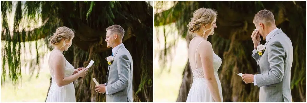 Snohomish Wedding Photographer GSquared Weddings A bride and groom stand outdoors under a tree. The bride, in a white lace dress, reads vows while the groom, in a light gray suit, listens and wipes his eye. Theyre exchanging heartfelt moments in a serene natural setting. Serving Seattle, Snohomish and Orlando