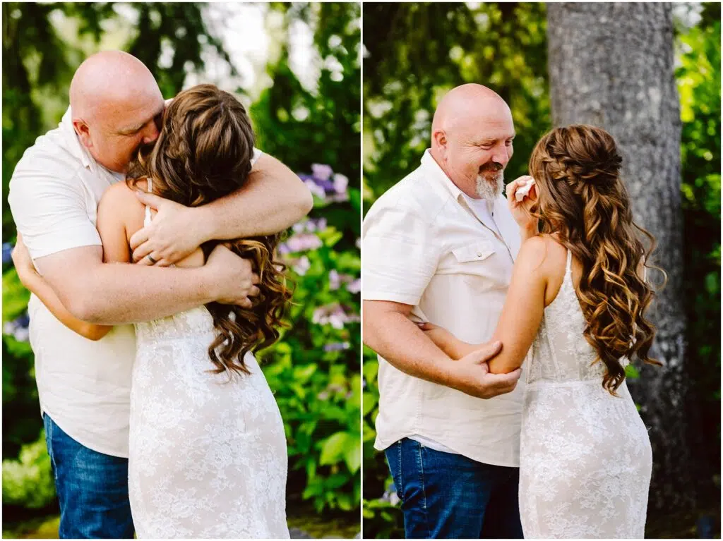 Snohomish Wedding Photographer GSquared Weddings A bald man in a white shirt embraces a woman in a white lace dress. They share an emotional moment outdoors, surrounded by greenery and flowers. She appears to be wiping a tear. Serving Seattle, Snohomish and Orlando