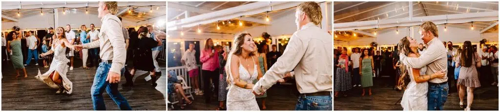 Snohomish Wedding Photographer GSquared Weddings A couple dances joyfully at a wedding reception. The bride, in a white dress, and the groom, in a white shirt and jeans, are surrounded by other guests on a wooden floor under a tent with string lights. Serving Seattle, Snohomish and Orlando