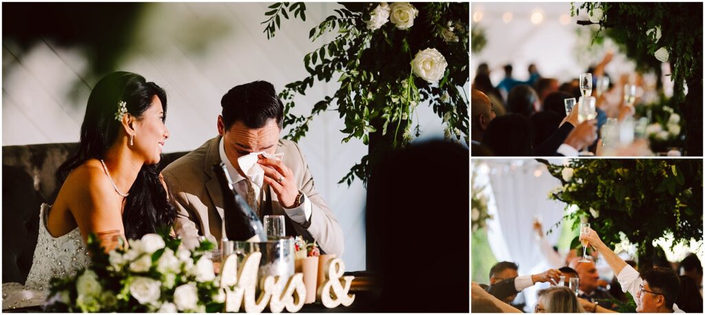 Snohomish Wedding Photographer GSquared Weddings A bride and groom sit together, the groom wiping tears, at a wedding reception. Nearby guests raise glasses in a toast. The setting is adorned with white flowers and greenery. Serving Seattle, Snohomish and Orlando