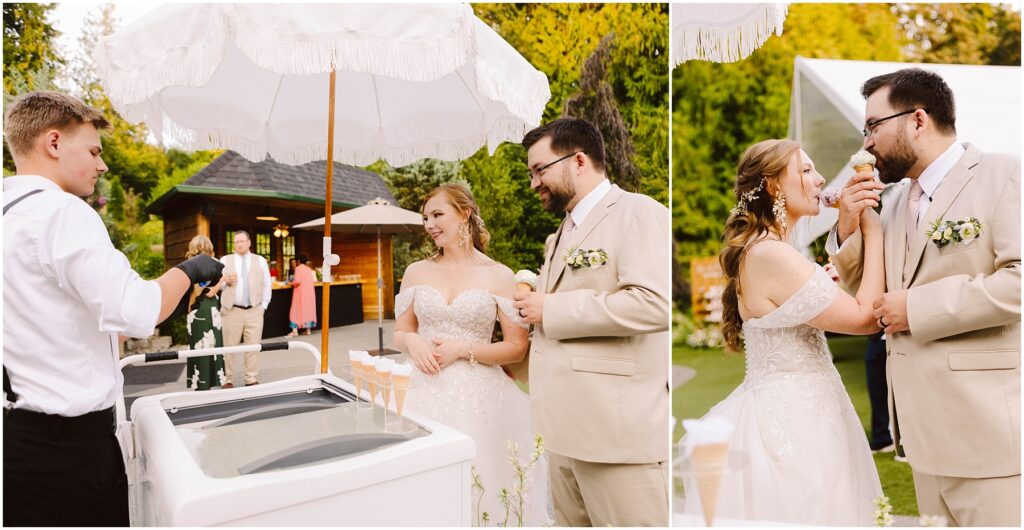 Snohomish Wedding Photographer GSquared Weddings A bride and groom in wedding attire enjoy ice cream from a vendor at an outdoor location. The groom feeds a cone to the bride, who smiles under a white umbrella. A wooden cabin and green trees are visible in the background. Serving Seattle, Snohomish and Orlando