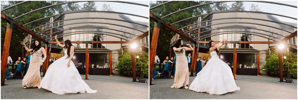 Snohomish Wedding Photographer GSquared Weddings Two women dancing outdoors under a clear canopy. One wears a white wedding gown and the other a light-colored, embellished dress. In the background, guests are seated, watching the performance amid greenery and a building with large windows. Serving Seattle, Snohomish and Orlando