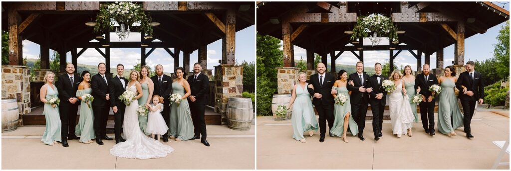 Snohomish Wedding Photographer GSquared Weddings Wedding party in formal attire poses and walks outside a rustic venue. The bridesmaids wear sage green dresses, and the groomsmen are in black suits. The bride is in a white gown. They are all smiling with greenery and wooden beams in the background. Serving Seattle, Snohomish and Orlando