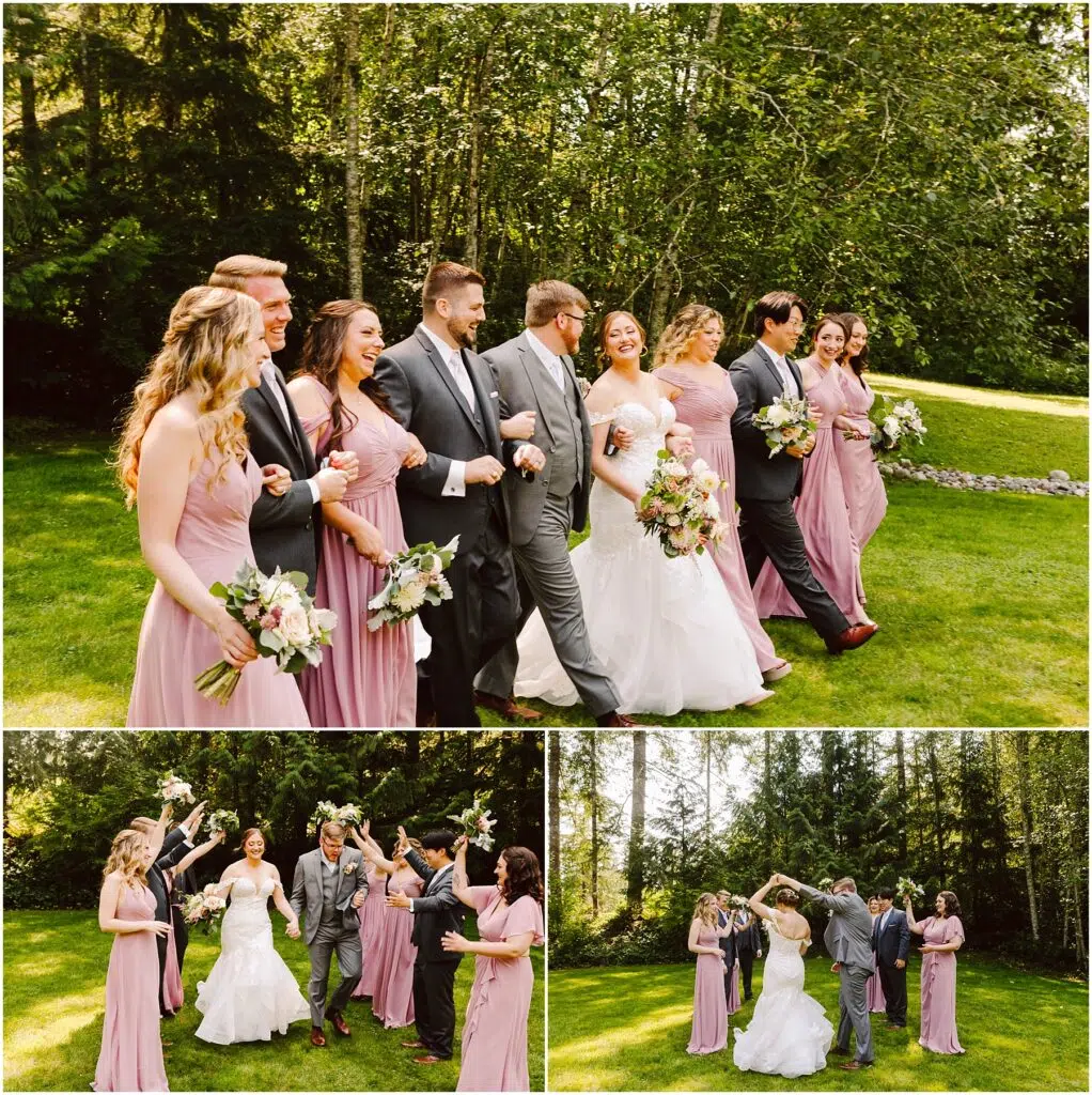 Snohomish Wedding Photographer GSquared Weddings A bride and groom walk arm-in-arm with their wedding party on a grassy outdoor area. Bridesmaids in pink dresses and groomsmen in gray suits surround them. They smile and celebrate under a sunny, tree-filled backdrop. Serving Seattle, Snohomish and Orlando