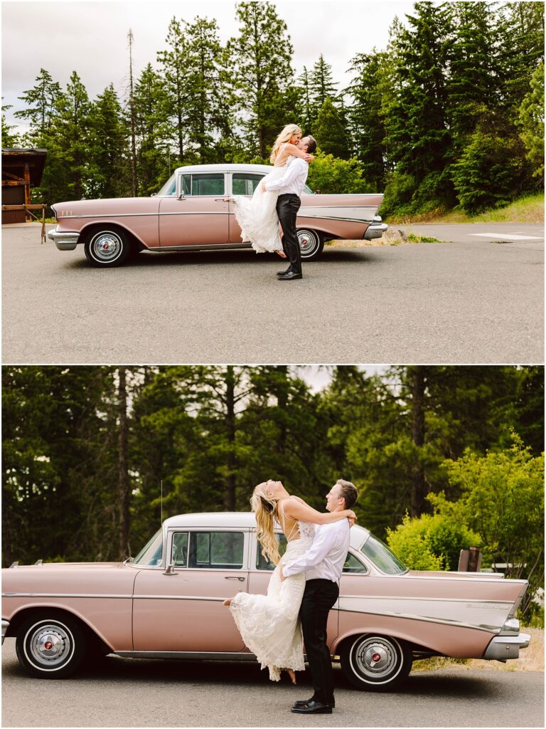 Snohomish Wedding Photographer GSquared Weddings A couple stands joyfully near a vintage pink car surrounded by tall trees. The man is lifting the woman, who wears a white dress, while he wears a white shirt and black pants. They appear happy and carefree. Serving Seattle, Snohomish and Orlando
