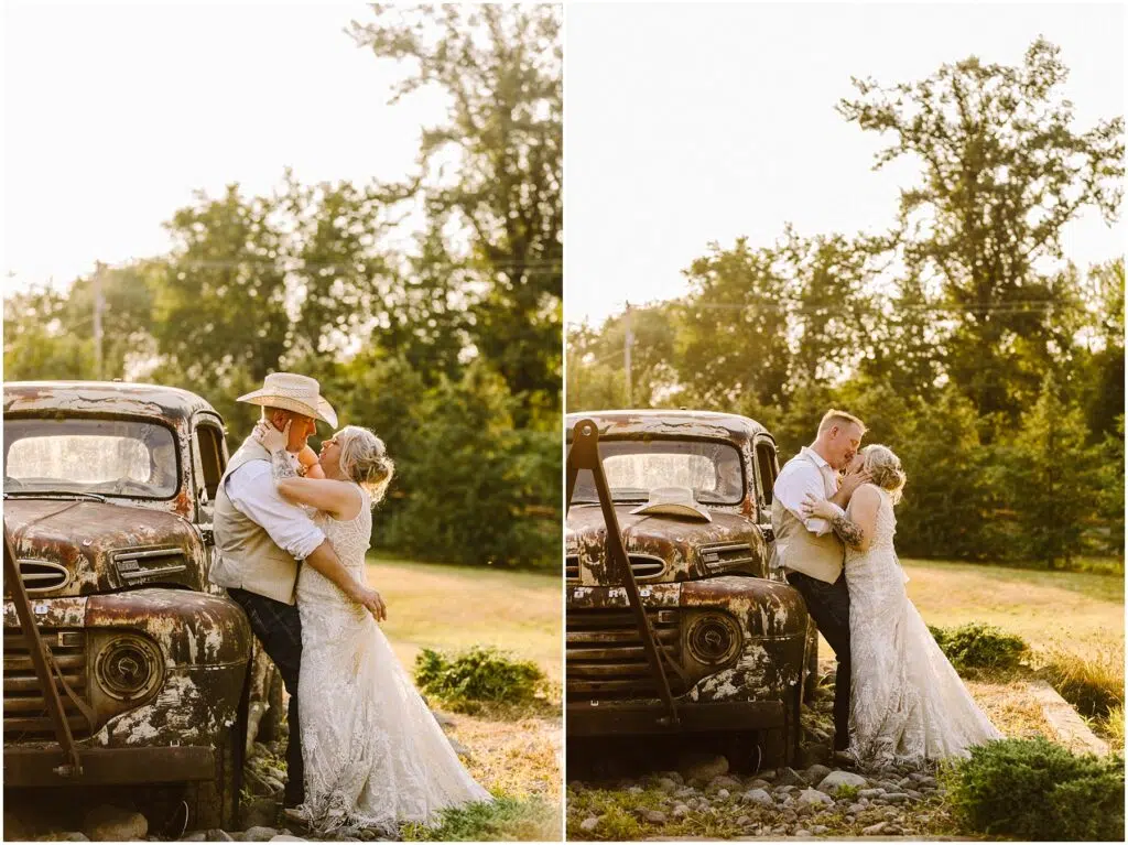 Snohomish Wedding Photographer GSquared Weddings A couple embraces by an old, rustic truck in a sunny field. The man wears a straw hat, white shirt, and vest, while the woman wears a white lace dress. Trees and grass are in the background, creating a warm, romantic setting. Serving Seattle, Snohomish and Orlando
