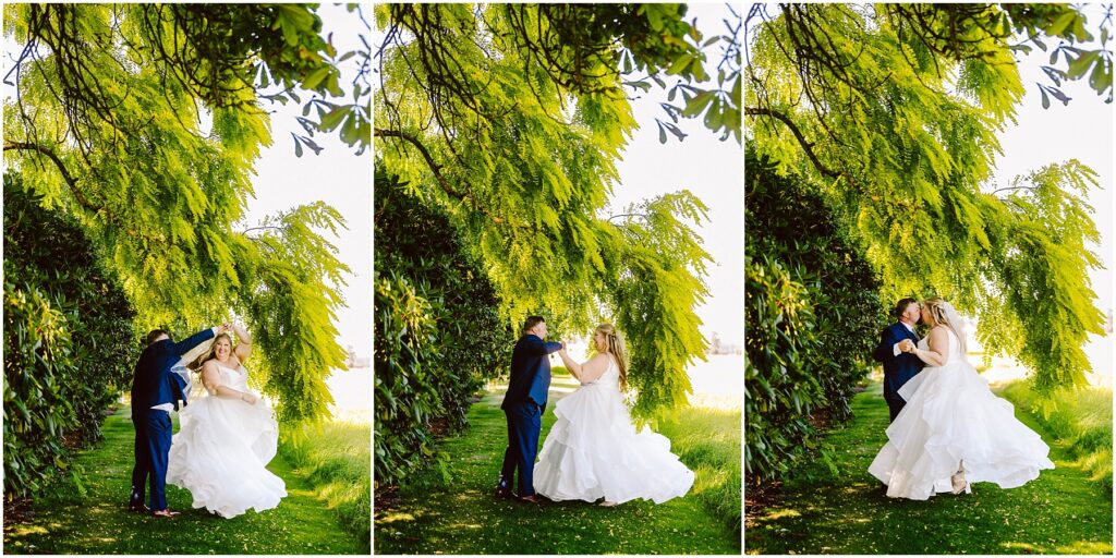 Snohomish Wedding Photographer GSquared Weddings A couple dances under lush, green trees in a sunlit outdoor setting. The bride wears a flowing white gown and the groom is in a dark suit. They are surrounded by vibrant greenery, creating a romantic and serene atmosphere. Serving Seattle, Snohomish and Orlando