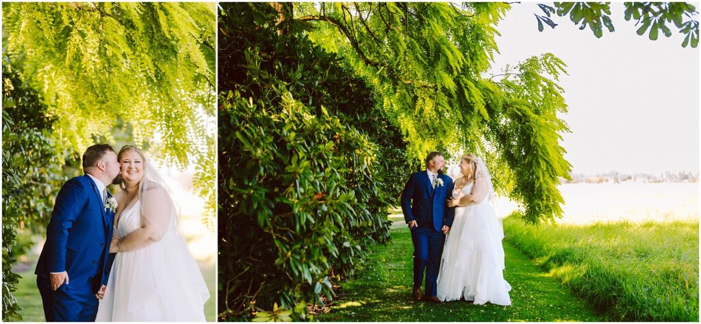 Snohomish Wedding Photographer GSquared Weddings A couple in wedding attire stands under a large, leafy tree, surrounded by greenery. The groom wears a blue suit, and the bride wears a white gown. They are smiling, with the groom kissing the brides cheek in one image. Sunlight filters through the leaves. Serving Seattle, Snohomish and Orlando