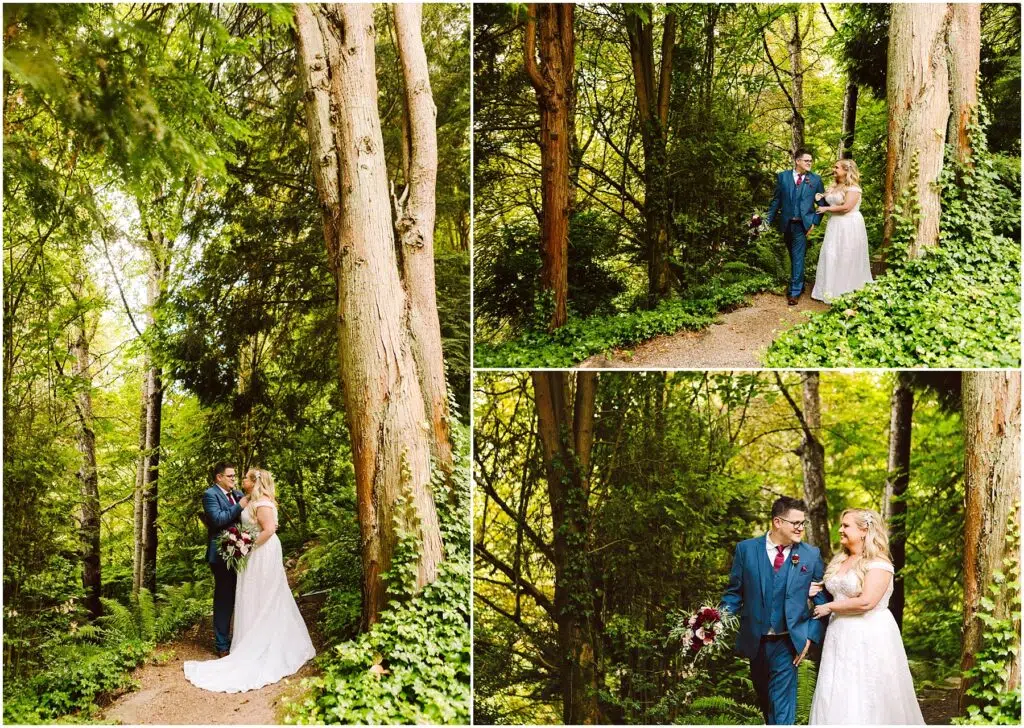 Snohomish Wedding Photographer GSquared Weddings A couple in wedding attire walks and embraces on a forest path. The groom wears a blue suit, and the bride wears a white dress. They are surrounded by lush green trees and foliage in a serene, natural setting. Serving Seattle, Snohomish and Orlando