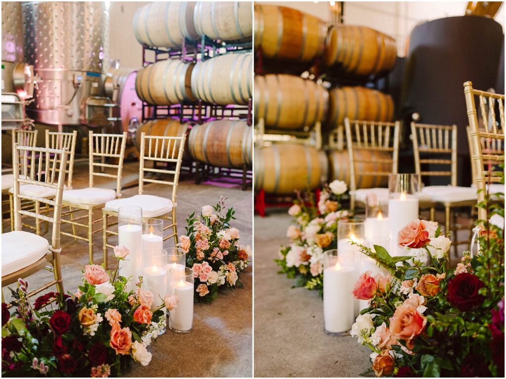 Snohomish Wedding Photographer GSquared Weddings Rows of gold chairs are arranged indoors beside large wine barrels. Floral arrangements with red, pink, and orange flowers, accompanied by lit candles, decorate the aisle. The setting has a warm and inviting atmosphere. Serving Seattle, Snohomish and Orlando