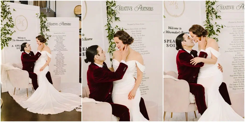 Snohomish Wedding Photographer GSquared Weddings A bride in a white gown and a groom in a burgundy suit embrace in front of a decorative backdrop with greenery. They share affectionate moments, with the groom seated and the bride standing or sitting on his lap in various poses. Serving Seattle, Snohomish and Orlando