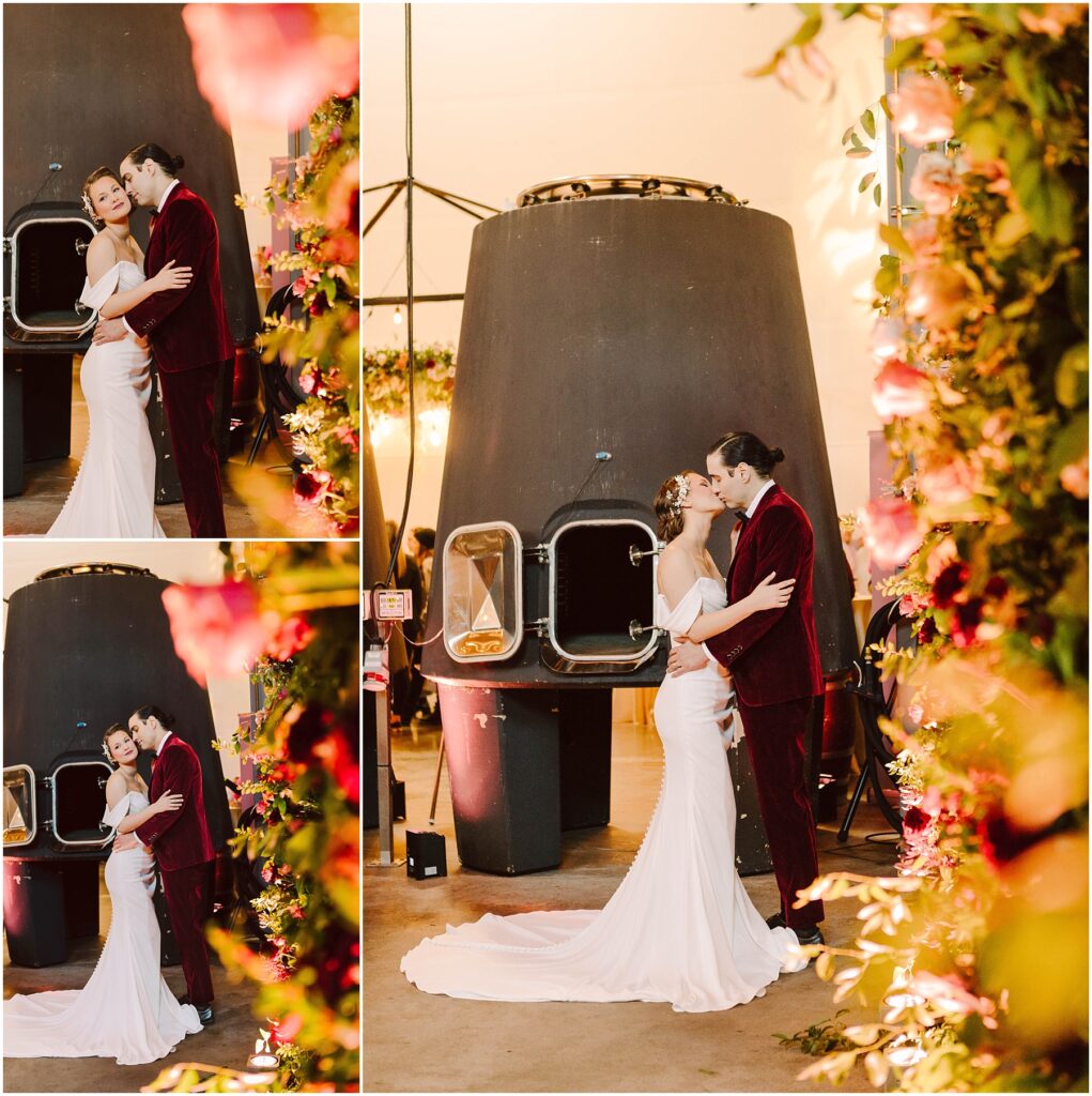 Snohomish Wedding Photographer GSquared Weddings A couple, dressed in wedding attire, embraces and kisses in front of a large industrial structure. Theyre surrounded by vibrant floral arrangements. The bride wears a white gown, and the groom is in a red suit. The scene has a warm, romantic ambiance. Serving Seattle, Snohomish and Orlando