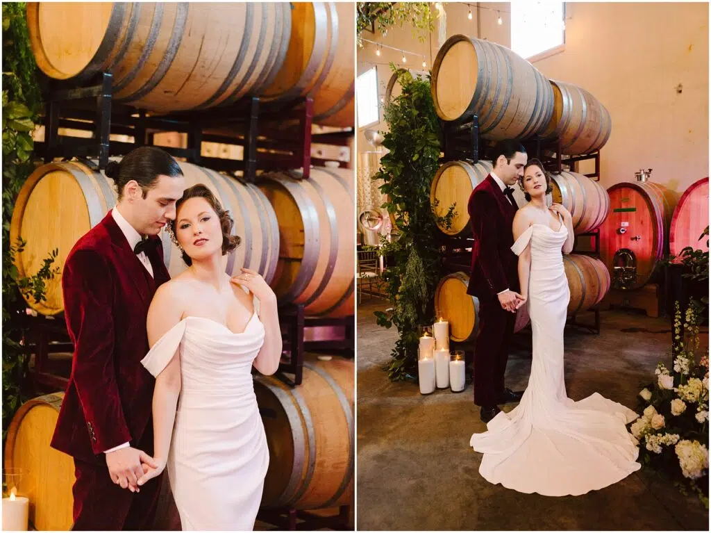 Snohomish Wedding Photographer GSquared Weddings A couple in formal attire poses in a winery. The woman wears an off-shoulder white gown, and the man wears a red velvet suit. They stand in front of wine barrels, surrounded by greenery and candles. The setting is elegant and romantic. Serving Seattle, Snohomish and Orlando