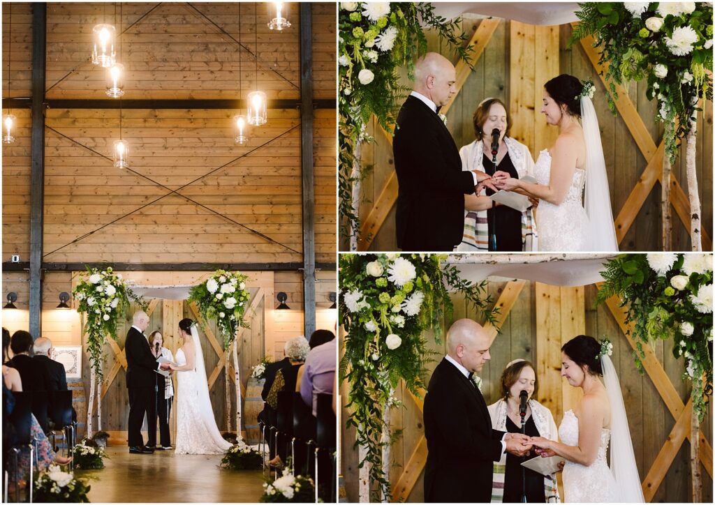 Snohomish Wedding Photographer GSquared Weddings A wedding ceremony in a wooden venue. A couple stands facing each other under an arch adorned with greenery and white flowers. They exchange vows with an officiant between them. Guests are seated, watching the ceremony. Serving Seattle, Snohomish and Orlando