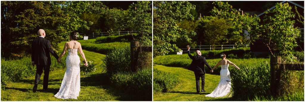 Snohomish Wedding Photographer GSquared Weddings A couple walks hand in hand on a sunlit grassy path, surrounded by lush greenery. The bride wears a strapless white gown, while the groom wears a black suit. They raise their joined hands in celebration, moving toward a scenic, tree-lined backdrop. Serving Seattle, Snohomish and Orlando