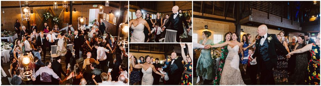 Snohomish Wedding Photographer GSquared Weddings A joyous wedding celebration in a wooden hall. The bride and groom dance energetically with guests forming a circle around them. The room is decorated with flowers and lit chandeliers, creating a festive atmosphere. Serving Seattle, Snohomish and Orlando