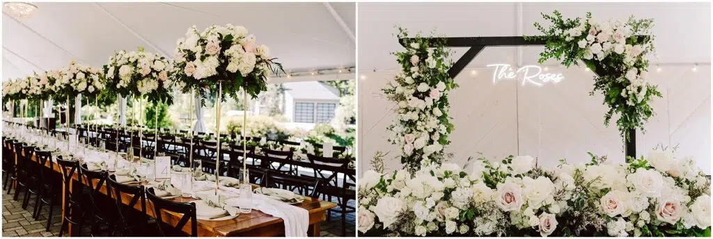 Snohomish Wedding Photographer GSquared Weddings Elegant wedding reception table under a white tent, adorned with tall floral centerpieces of white and pink roses. A wooden arch decorated with similar flowers and a The Rose neon sign is visible in the background. Serving Seattle, Snohomish and Orlando