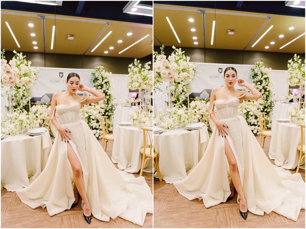 Snohomish Wedding Photographer GSquared Weddings A woman in a strapless gown with a thigh-high slit stands confidently in a decorated room. The background features white floral arrangements, elegant table settings, and soft lighting, creating a sophisticated and luxurious ambiance. Serving Seattle, Snohomish and Orlando