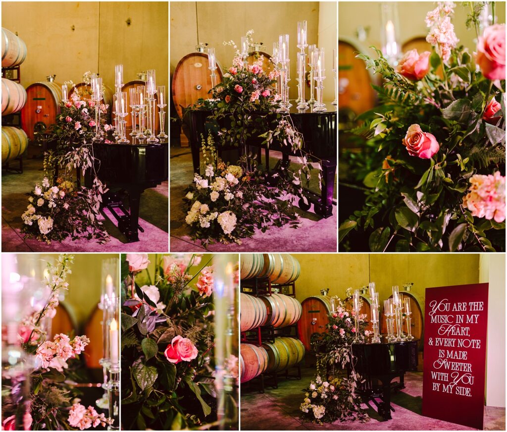 Snohomish Wedding Photographer GSquared Weddings A grand piano is adorned with floral arrangements featuring pink, white, and cream flowers. Candle holders are placed on and around the piano. Wine barrels are visible in the background. A sign reads, You are the music in my heart & every note is made sweeter with you by my side. Serving Seattle, Snohomish and Orlando