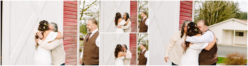 Snohomish Wedding Photographer GSquared Weddings A bride with floral hair adornments embraces two men in separate hugs, both wearing suits. They stand by a rustic red and white barn in Machias. A white house and trees are visible in the background under a cloudy sky. Serving Seattle, Snohomish and Orlando