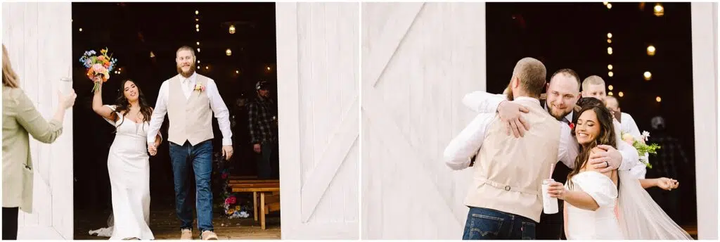 Snohomish Wedding Photographer GSquared Weddings A newlywed couple exits a barn in Machias, smiling and holding hands. The bride waves a vibrant bouquet as they are greeted by guests with hugs and joyful expressions, celebrating the occasion. Serving Seattle, Snohomish and Orlando