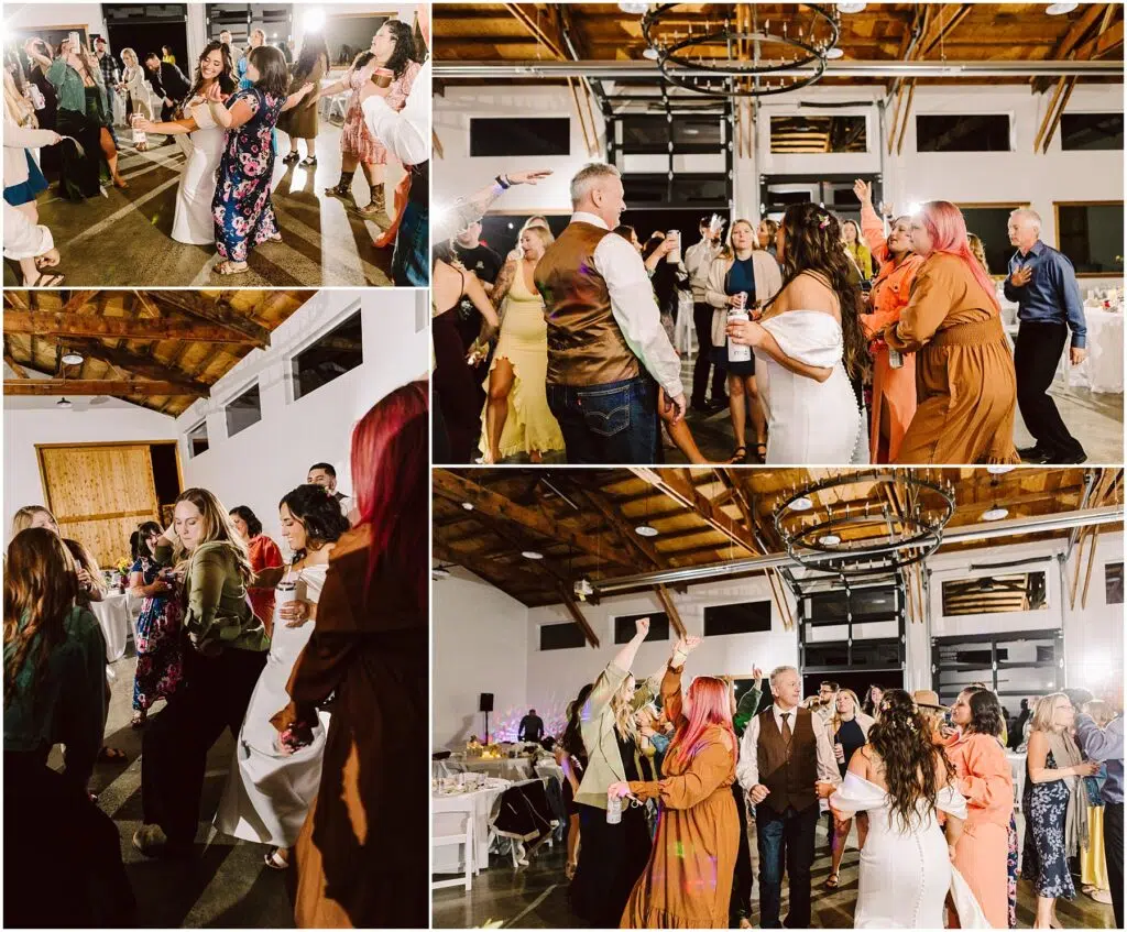 Snohomish Wedding Photographer GSquared Weddings Guests joyfully dance at a lively indoor wedding reception in Machias. They are in a spacious venue with wooden ceilings and modern chandeliers. People display a range of colorful outfits, adding to the festive atmosphere. Serving Seattle, Snohomish and Orlando