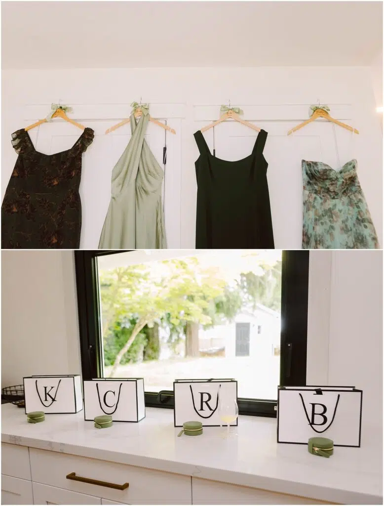 Snohomish Wedding Photographer GSquared Weddings Four dresses hang on a wall: a dark patterned one, a light green, a black, and floral—perfect for a summer wedding in Port Gamble. Below, four black-edged placards with the letters K, C, R, and B adorn the countertop with small green candles beside each. Serving Seattle, Snohomish and Orlando