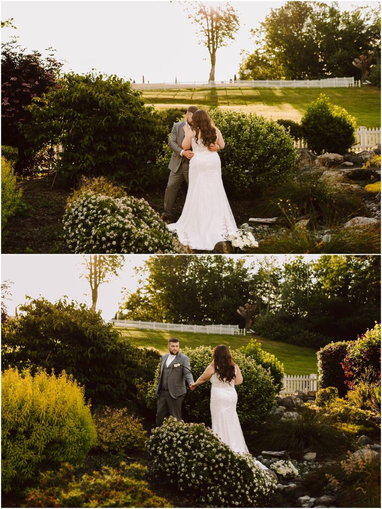 Snohomish Wedding Photographer GSquared Weddings A bride in a white gown and a groom in a gray suit share a moment in Port Gambles lush garden. They are surrounded by blooming flowers and greenery, with a rustic fence and trees under the clear summer wedding sky. Serving Seattle, Snohomish and Orlando