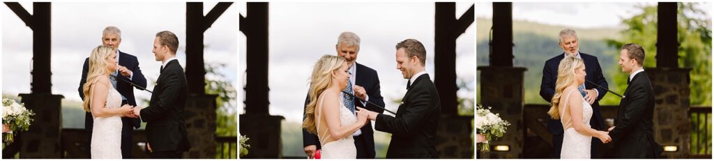 Snohomish Wedding Photographer GSquared Weddings A couple in wedding attire shares a joyful moment while exchanging vows at a picturesque winery. A man stands behind them officiating the ceremony amidst lush greenery and charming wooden structures. Serving Seattle, Snohomish and Orlando