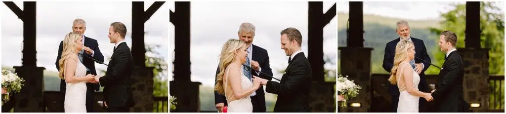 Snohomish Wedding Photographer GSquared Weddings A couple in wedding attire shares a joyful moment while exchanging vows at a picturesque winery. A man stands behind them officiating the ceremony amidst lush greenery and charming wooden structures. Serving Seattle, Snohomish and Orlando