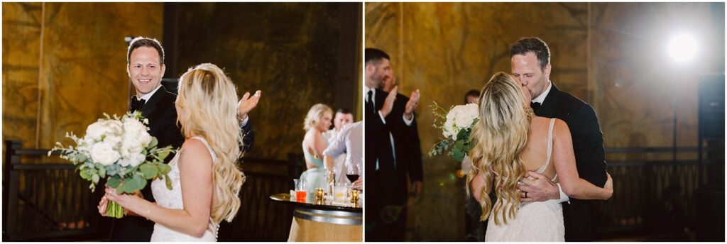 Snohomish Wedding Photographer GSquared Weddings A couple in formal attire shares a joyful moment at a winery celebration. The man, wearing a tuxedo, smiles broadly with open arms, while the woman, in a white dress holding a bouquet, looks at him. They are surrounded by applauding guests amid the rustic charm of the vineyard. Serving Seattle, Snohomish and Orlando