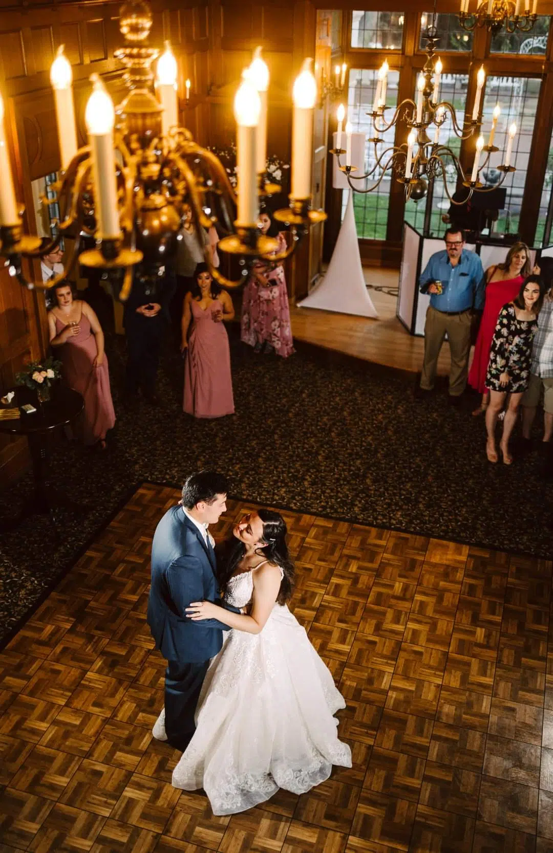 Snohomish Wedding Photographer GSquared Weddings A bride and groom share their first dance on a wooden floor in an elegant room with chandeliers while guests in formal attire watch from the sides Serving Seattle Snohomish and Orlando Snohomish Wedding Photographer GSquared Weddings A bride and groom share their first dance on a wooden floor in an elegant room with chandeliers while guests in formal attire watch from the sides Serving Seattle Snohomish and Orlando