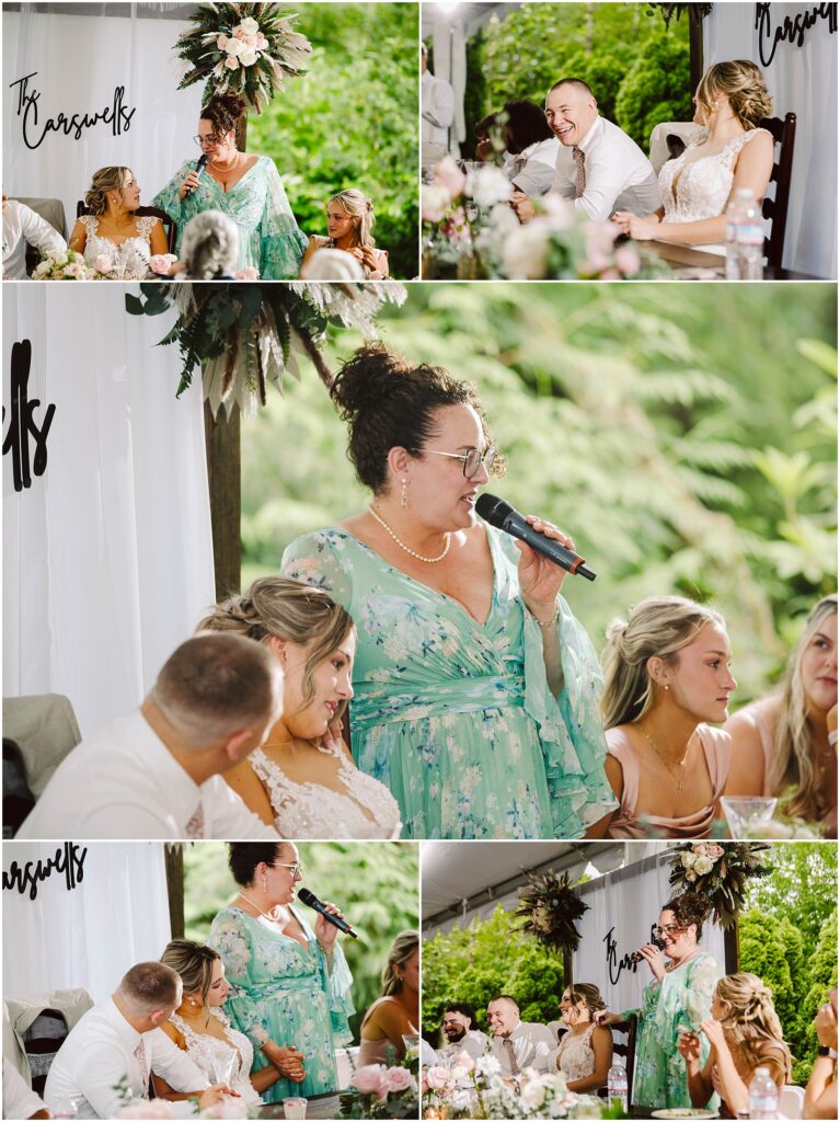 Snohomish Wedding Photographer GSquared Weddings A woman in a light green dress speaks into a microphone at a wedding reception in Snohomish. She stands next to seated guests, surrounded by lush greenery and floral decorations. Various guests listen attentively, with smiles and light conversation floating through the air. Serving Seattle, Snohomish and Orlando