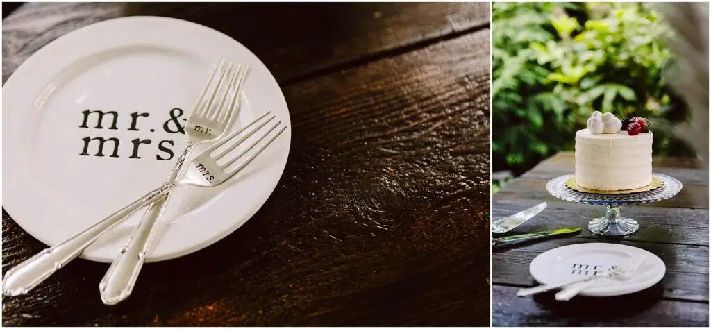 Snohomish Wedding Photographer GSquared Weddings Close-up of a mr. & mrs. plate with two forks on a wooden table in Snohomish. Next to it, a small white cake with a raspberry, on a glass stand, surrounded by plants. A cake server and small plate are nearby. Serving Seattle, Snohomish and Orlando