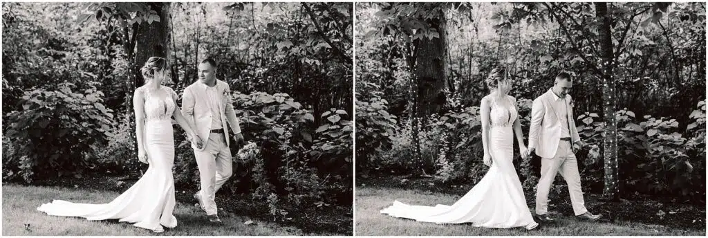 Snohomish Wedding Photographer GSquared Weddings A couple in wedding attire strolls through a Snohomish garden. The bride wears a long, elegant gown while the groom is in a light-colored suit. They hold hands and smile at each other, creating a timeless black-and-white scene. Serving Seattle, Snohomish and Orlando