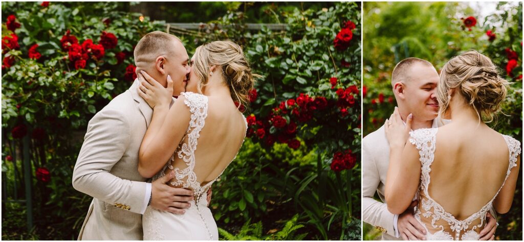 Snohomish Wedding Photographer GSquared Weddings In a lush Snohomish garden with red roses, a couple embraces tenderly. The woman, in her white lace-back dress, and the man in his light-colored suit appear joyful and affectionate, surrounded by vibrant greenery and flowers. Serving Seattle, Snohomish and Orlando
