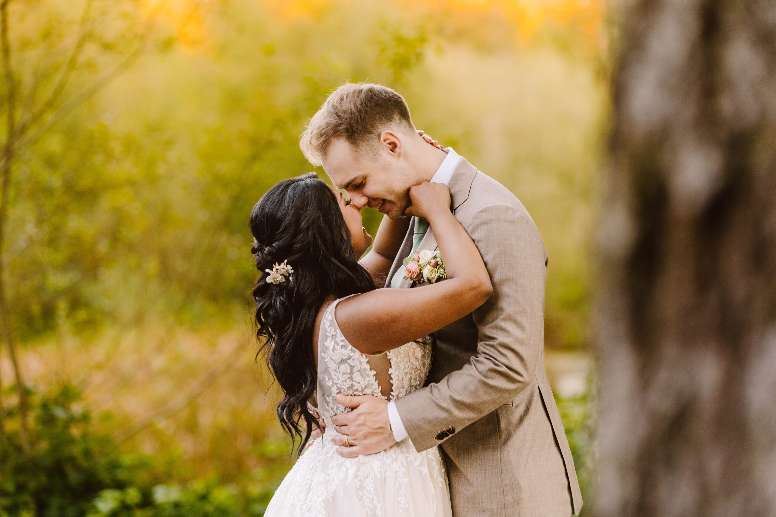 GSquared Weddings Photography A bride and groom embrace outdoors, smiling with their foreheads touching. Surrounded by greenery and golden light, the couple radiates joy—a perfect moment captured by GSquared Weddings Photography. GSquared Weddings | 47.9129° N, 122.0982° W | Serving Snohomish, Seattle , Orlando & Beyond