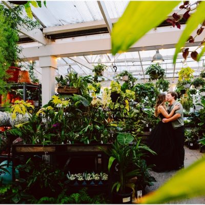 Christianson Nursery engagement session bride in black formal gown among nursery plants
